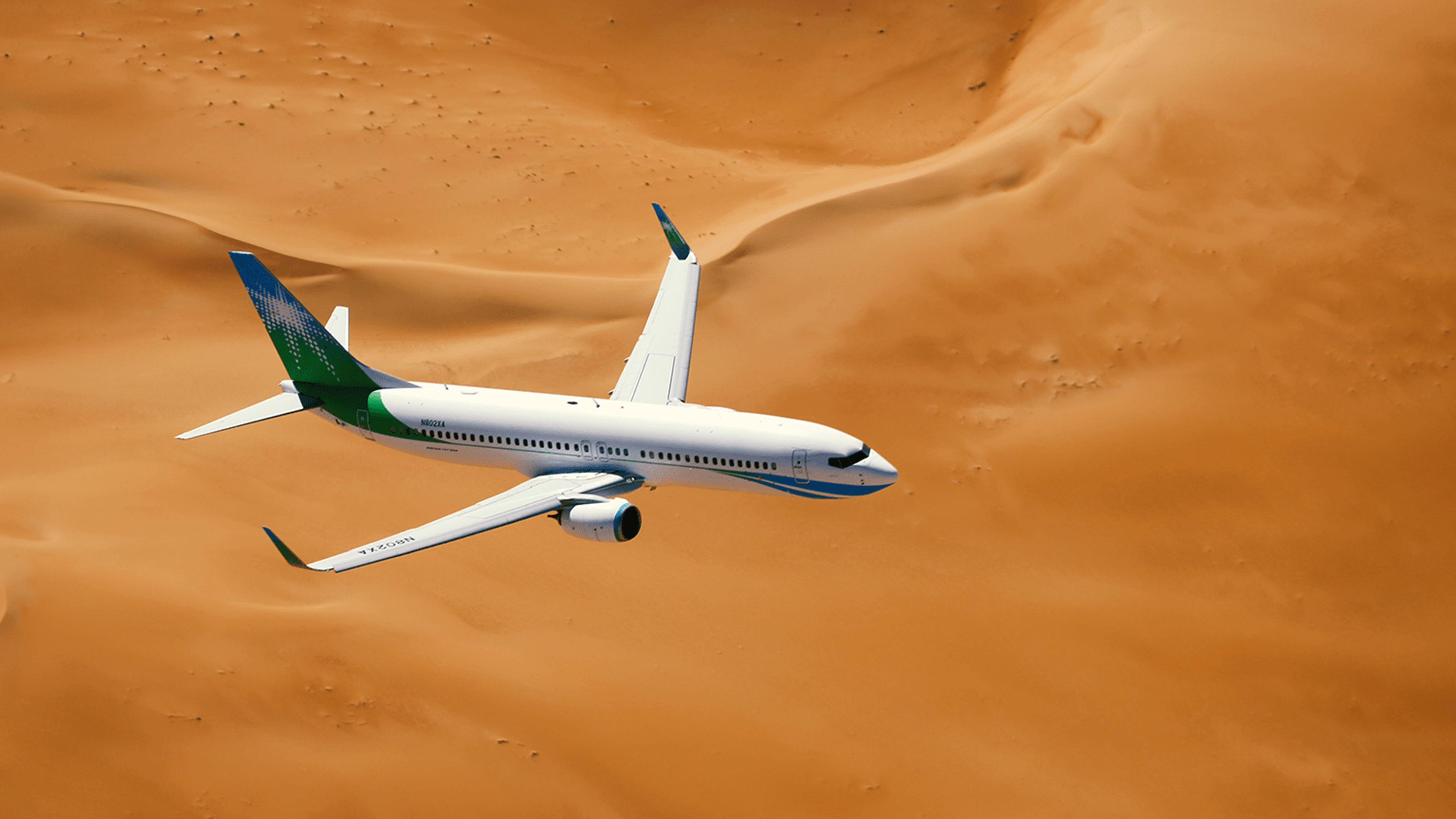 Saudi Aramco (Mukamalah) airplane flying through the sandy Arabian golden desert