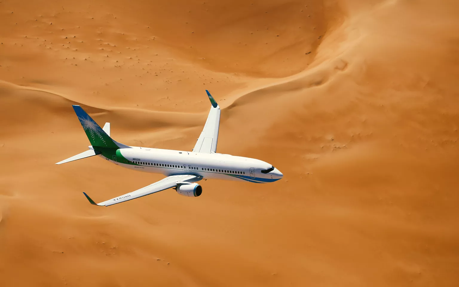 Saudi Aramco (Mukamalah) airplane flying through the sandy Arabian golden desert