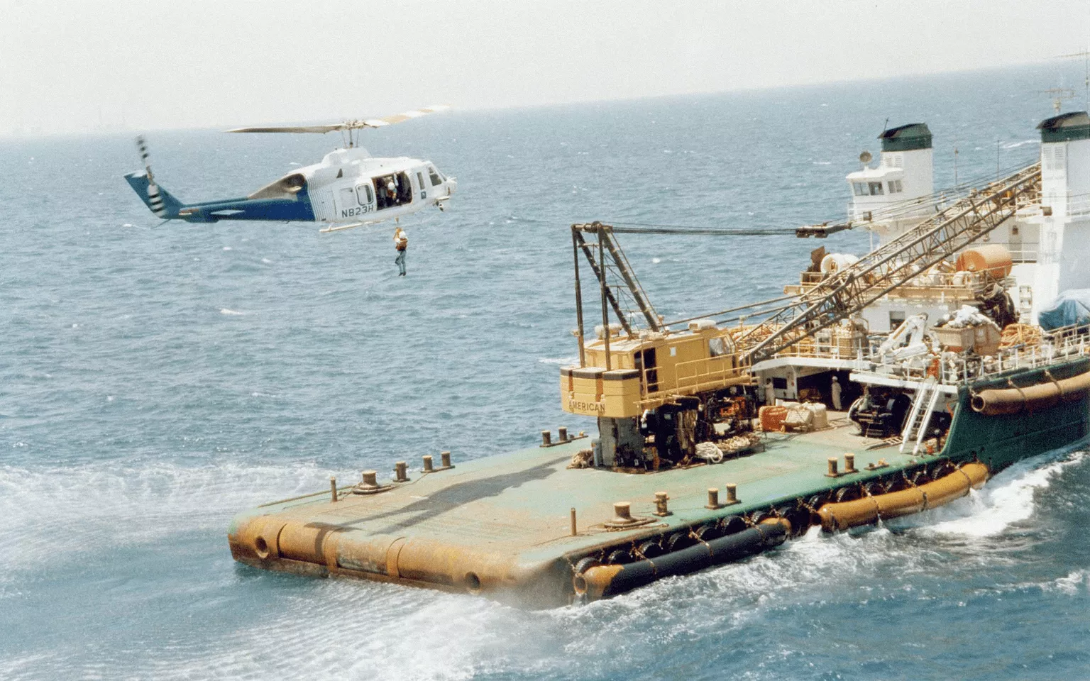Mukamalah helocopter performing a maritime landing on a ship dock