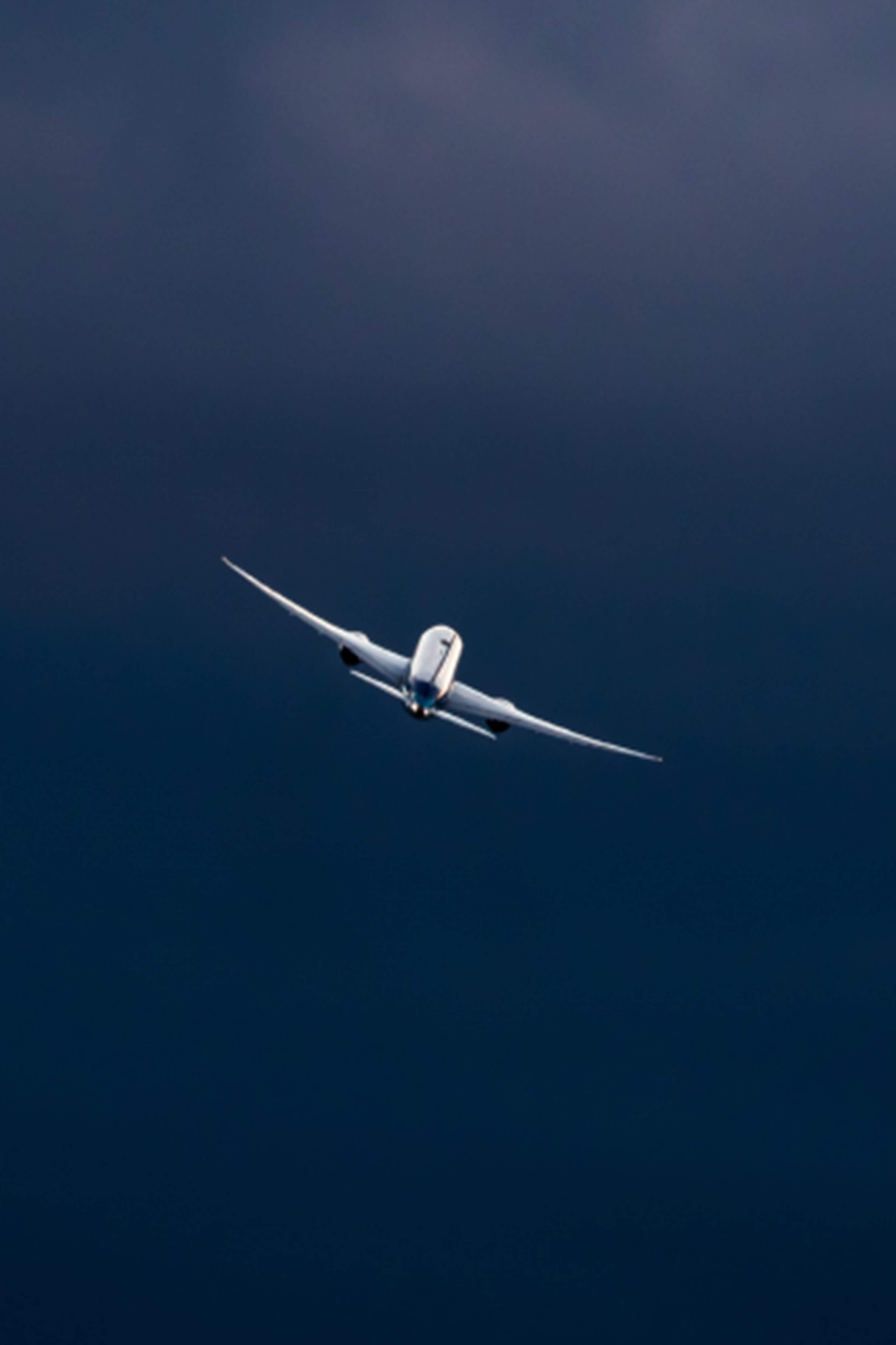 Airplane flying through the blue sky