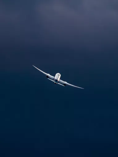 Airplane flying through the blue sky